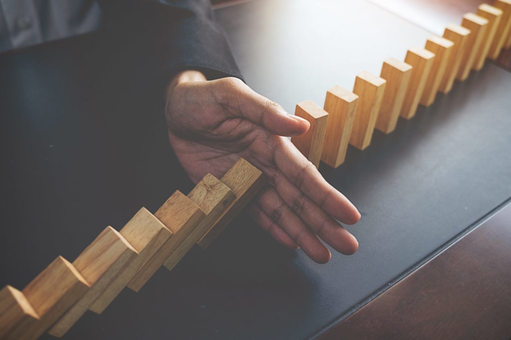 problem solving close up view hand business woman stopping falling blocks table concept about taking responsibility